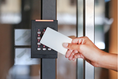 Person holding card to keypad